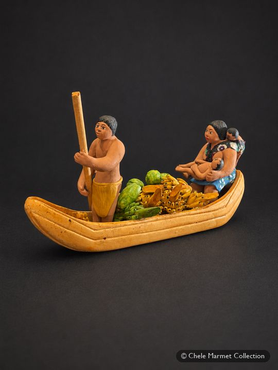Painted ceramic boat carrying a man with a pole, a pile of fruit and a woman holding twins.