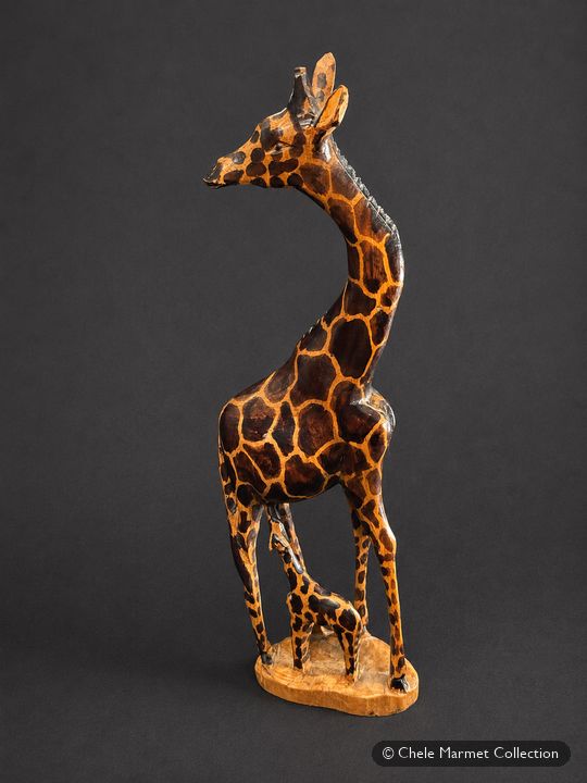 Carved wooden giraffe with brown painted spots.