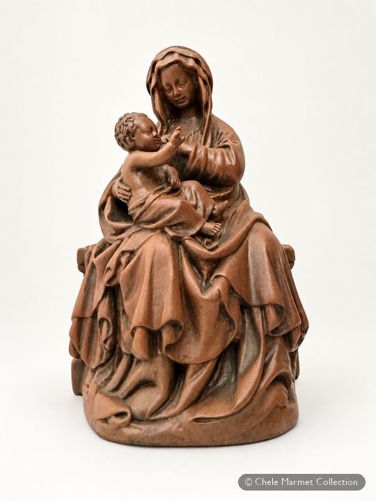 Brown statuette of a veiled seated Madonna nursing a child on her lap.