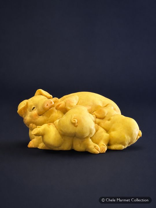 Yellow figurine of a group of piglets.