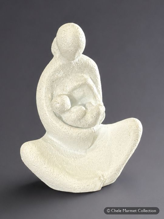 Smooth white abstract sculpture of a mother curved around a baby.