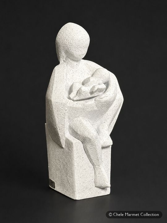 White sculpture of a seated mother cradling a baby.