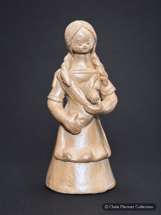 Unglazed clay figure of a young woman with long braids holding a baby in a sling at her breast.