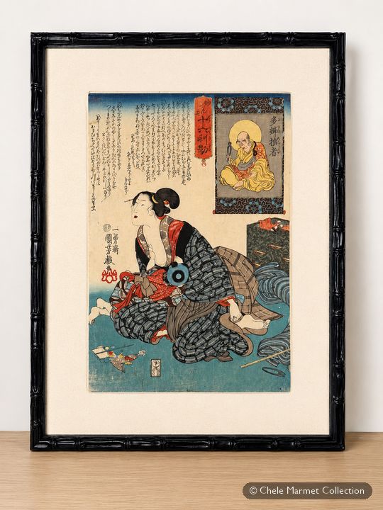 Framed Japanese print of a woman in a patterned kimono, seated and nursing a child, with an inset portrait and calligraphy above.