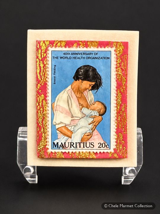 Stamp from Mauritius of a mother nursing a baby, mounted on a card.