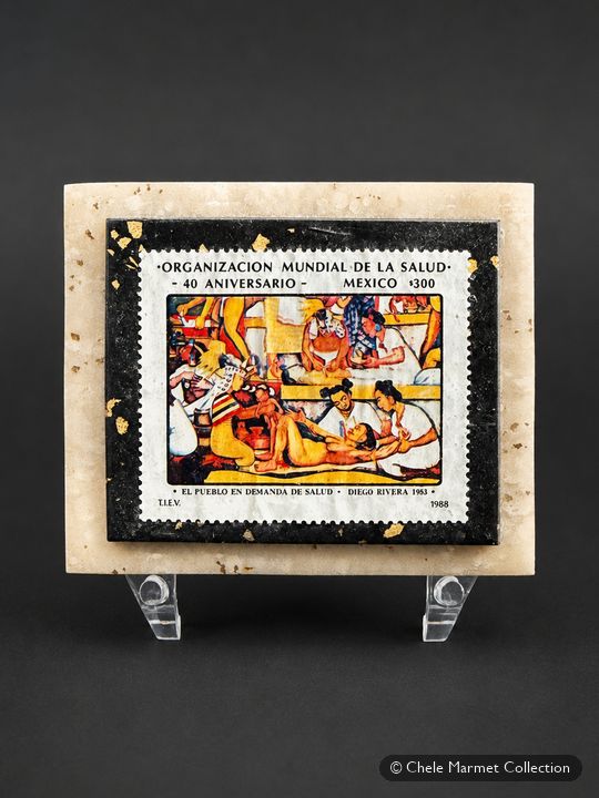 Colourful Mexican stamp mounted on a marble-patterned card on a clear stand.