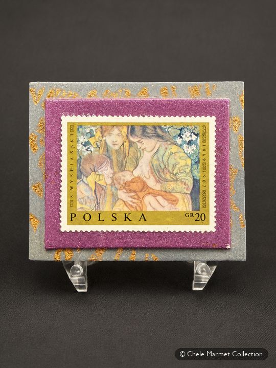 Polish stamp mounted on a purple card on a clear stand.