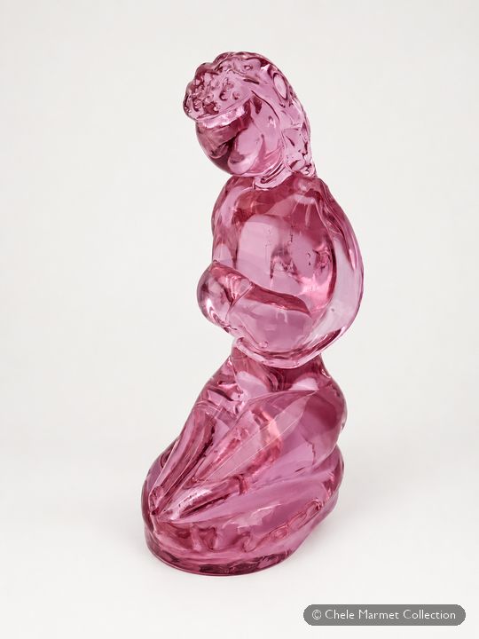 Translucent deep-pink glass figure of a kneeling woman holding a baby.